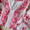 Close-up of the Beautiful White Chikankari Set in Shaded Pink featuring intricate handcrafted Chikankari embroidery on the neckline and sleeves.