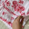 Close-up of the layered modal palazzo from the Beautiful White Chikankari Set in Shaded Pink featuring intricate handcrafted pink Chikankari embroidery and floral motifs.