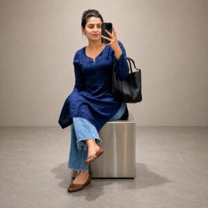 Woman wearing a Gorgeous Navy Blue Chikankari Kurti with Denims featuring elegant Lucknowi Chikankari work.