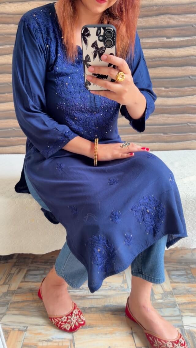 Mesmerizing Mukaish Chikankari Kurti with Denims 4 Mesmerizing Mukaish Chikankari Kurti with Denims styled in a sitting front pose