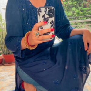 Mesmerizing Mukaish Chikankari Kurti with Denims in sitting pose, full view