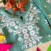 Pastel Sea Green Muslin Chikankari Kurta Set 5 Folded detail of the pastel sea green muslin chikankari kurta featuring elegant chikankari embroidery.