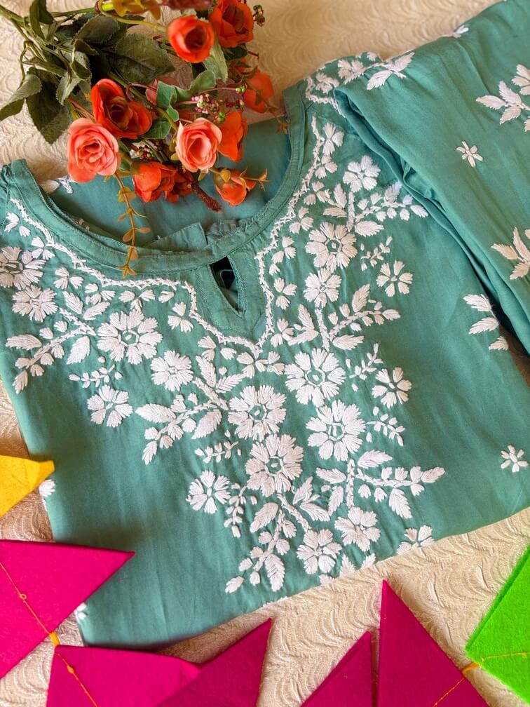 Pastel Sea Green Muslin Chikankari Kurta Set 3 Folded detail of the pastel sea green muslin chikankari kurta featuring elegant chikankari embroidery.