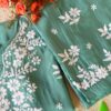 Folded angle view of the pastel sea green muslin chikankari kurta set with elegant embroidery details.