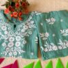 Folded front view of the Pastel Sea Green Muslin Chikankari Kurta Set with elegant Chikankari embroidery.