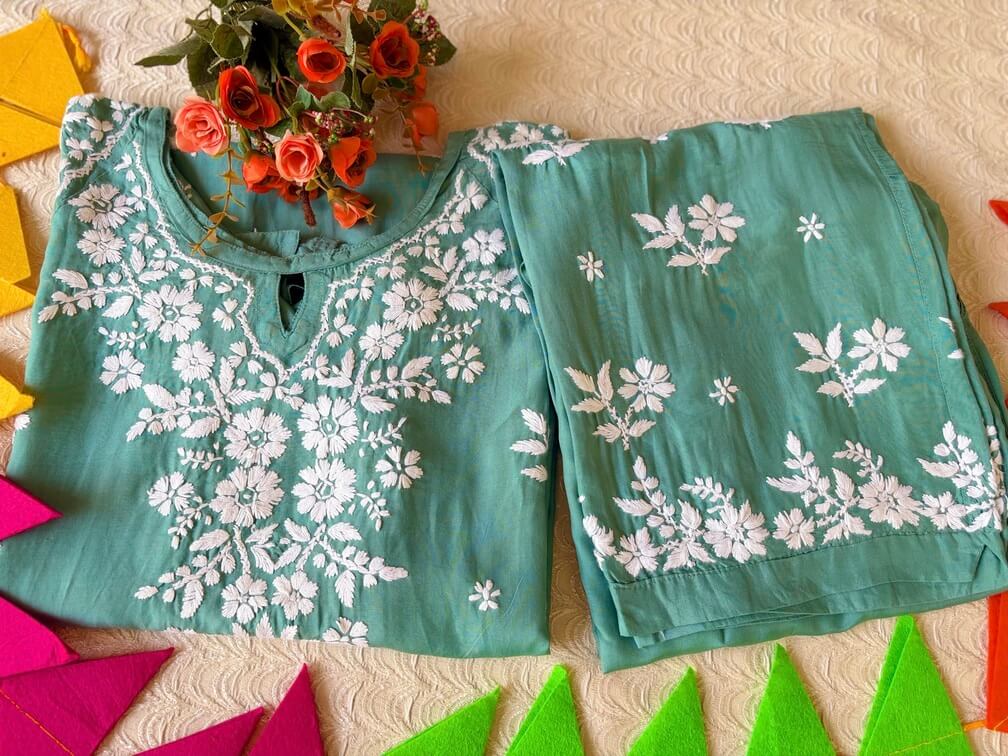 Pastel Sea Green Muslin Chikankari Kurta Set 1 Folded front view of the Pastel Sea Green Muslin Chikankari Kurta Set with elegant Chikankari embroidery.