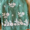 Folded muslin pant detail of the pastel sea green chikankari kurta set showcasing the soft, comfortable fabric.